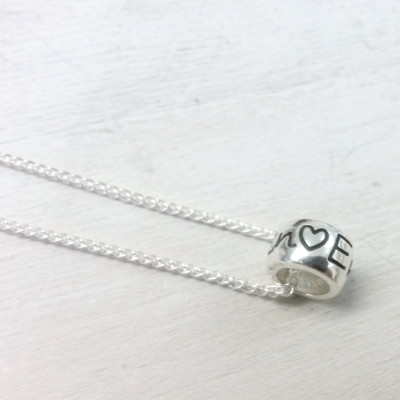 Personalised Mojo Charm Bead silver necklace - deeply engraved with name, date, phrase plus anchor, heart, flower and star symbols.